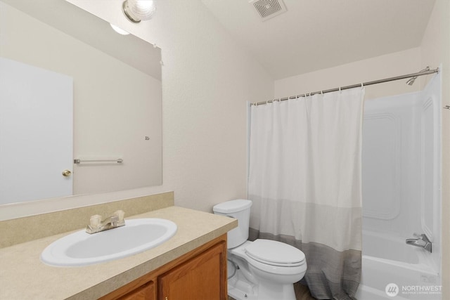 bathroom featuring toilet, shower / bath combo, visible vents, and vanity