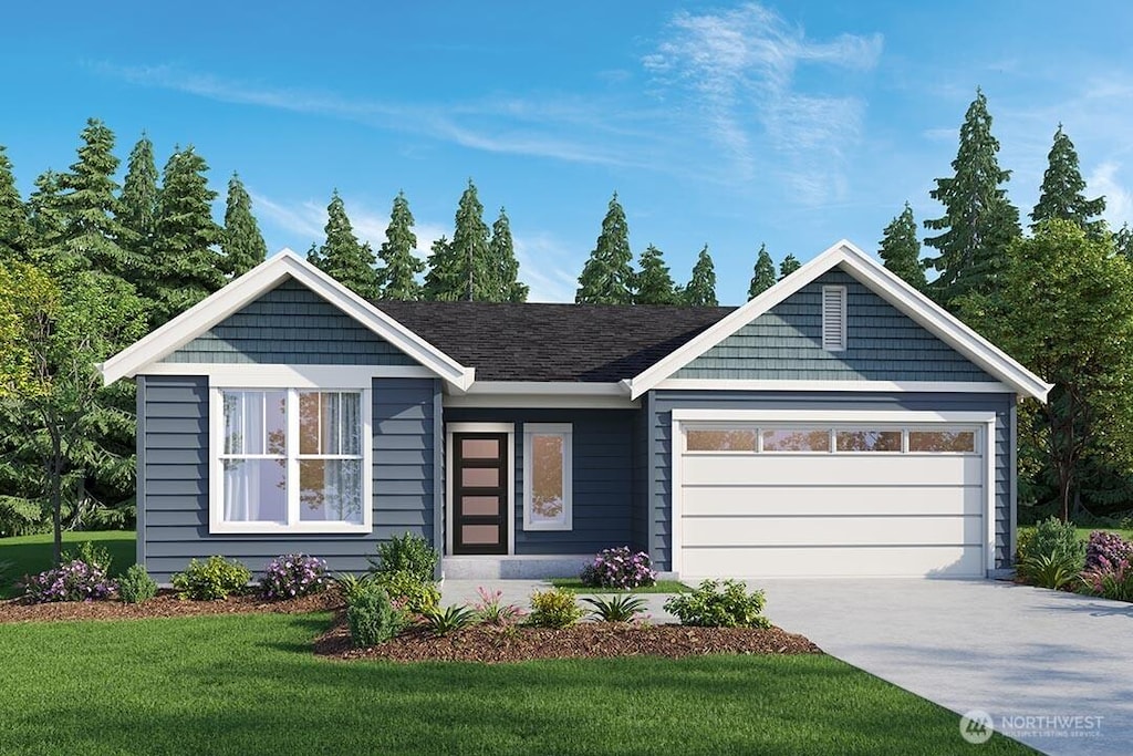 view of front of property featuring a garage and a front yard