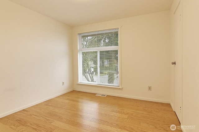 empty room with light hardwood / wood-style flooring