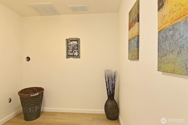 hallway with light hardwood / wood-style floors