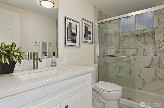 bathroom with vanity, toilet, and walk in shower