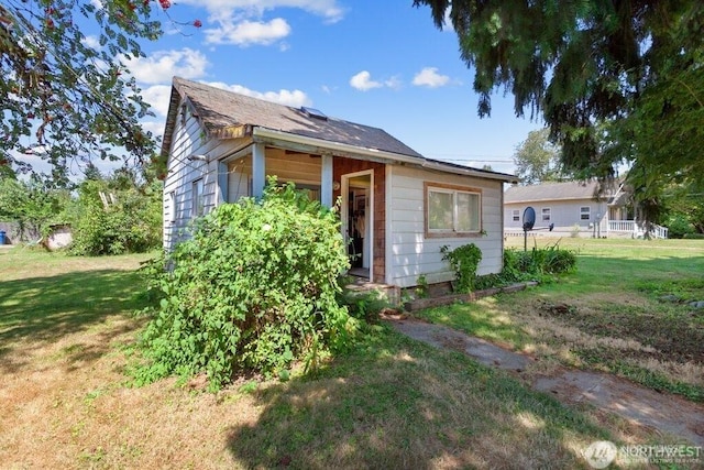 bungalow-style house with a front yard