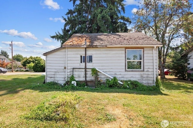 view of home's exterior with a lawn