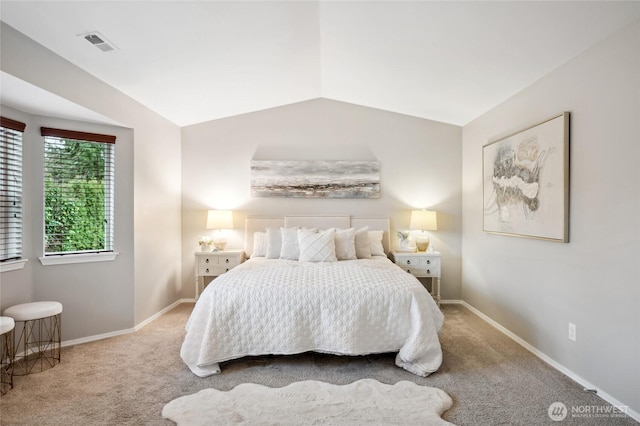 bedroom with vaulted ceiling and carpet floors