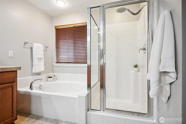 bathroom featuring plus walk in shower and vanity