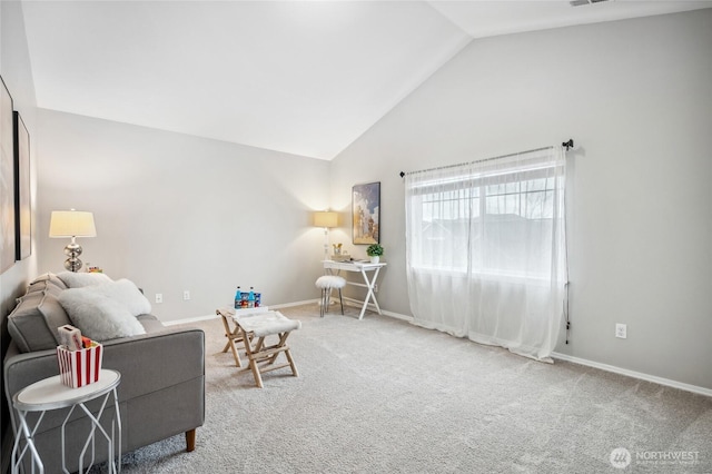 carpeted living room with high vaulted ceiling