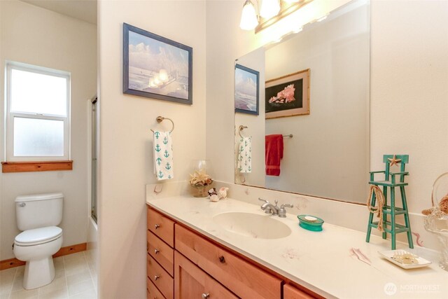 full bathroom featuring tile patterned flooring, toilet, vanity, and baseboards