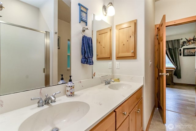 full bath featuring tile patterned flooring, a shower stall, double vanity, and a sink