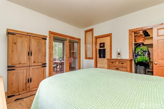 bedroom featuring light wood-style flooring, a closet, access to exterior, and a spacious closet