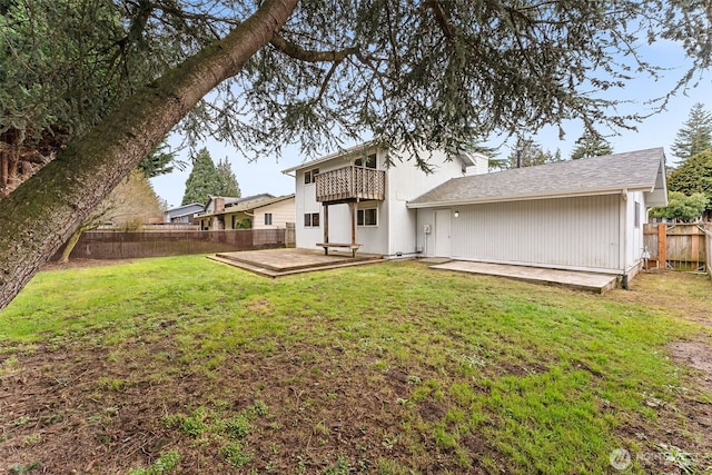 rear view of property featuring a lawn, a patio area, a fenced backyard, and a balcony