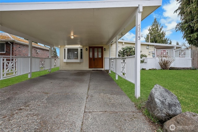 view of patio / terrace with an attached carport, fence, and driveway