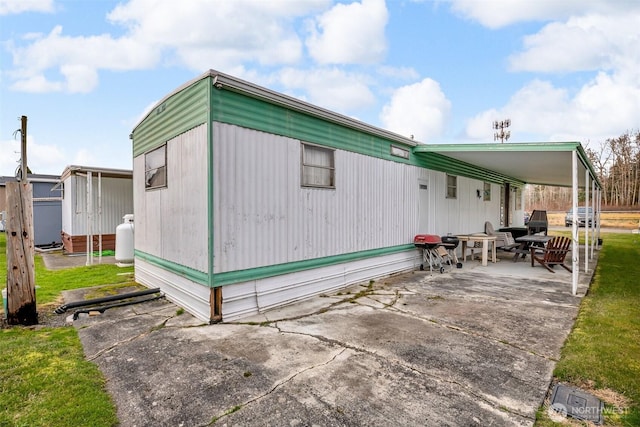 view of side of home featuring a patio area