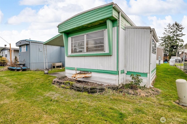 view of side of property with a lawn