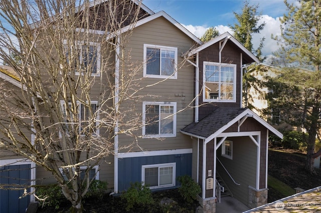 view of front of property with board and batten siding and roof with shingles