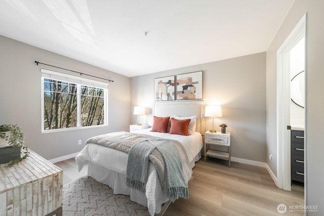 bedroom featuring light wood-type flooring and baseboards