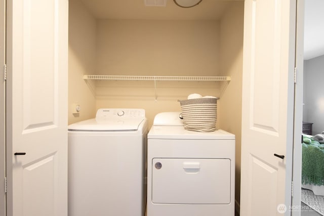 washroom with laundry area, visible vents, and independent washer and dryer