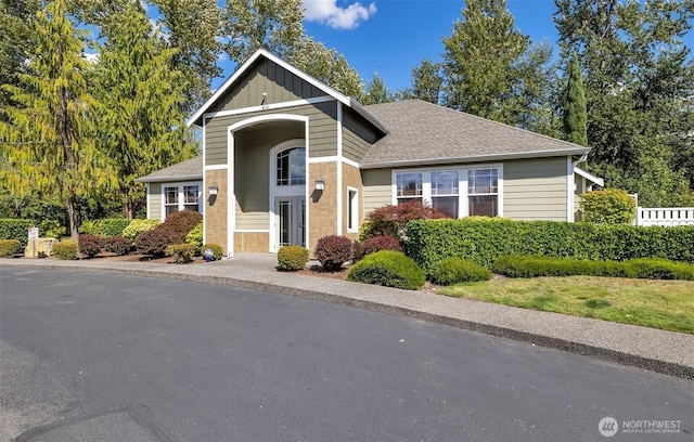 view of front of house featuring a shingled roof and board and batten siding