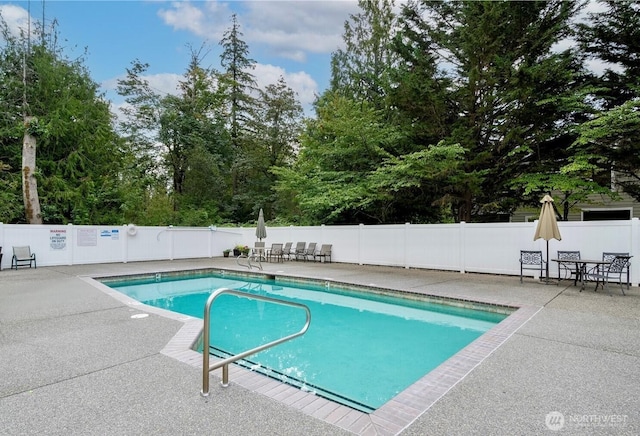 view of pool featuring fence, a fenced in pool, and a patio