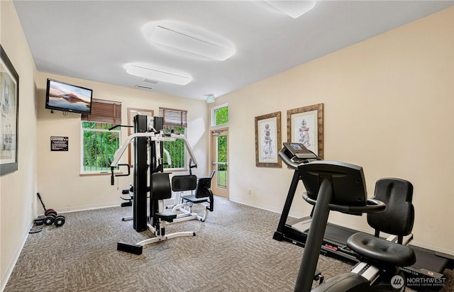 workout room with carpet floors and baseboards