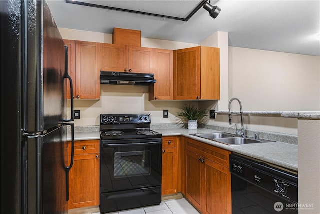 kitchen featuring sink, black appliances, and light tile patterned flooring