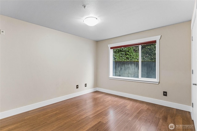 empty room with wood-type flooring