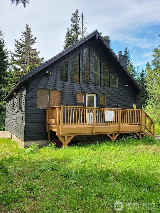 back of house featuring a deck and a chimney