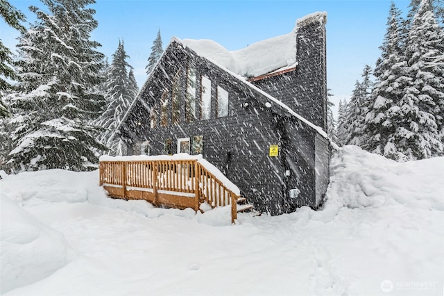 snow covered property featuring a wooden deck