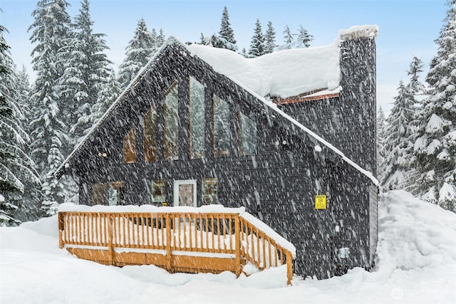 exterior space with a deck and a detached garage