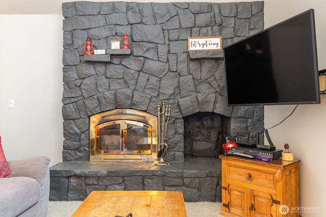 living room featuring a stone fireplace