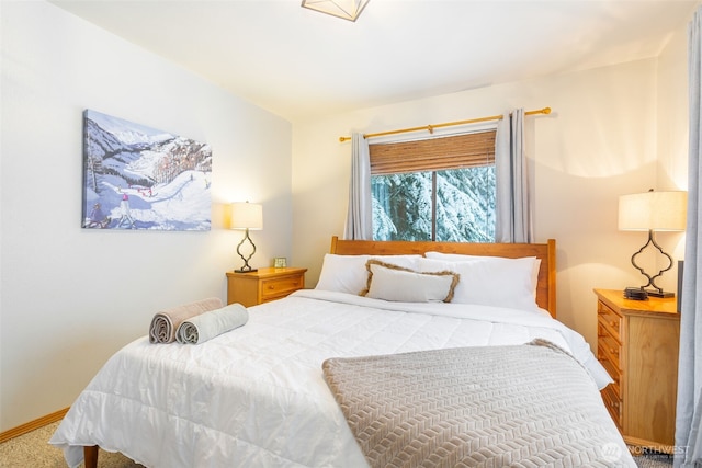 carpeted bedroom with baseboards