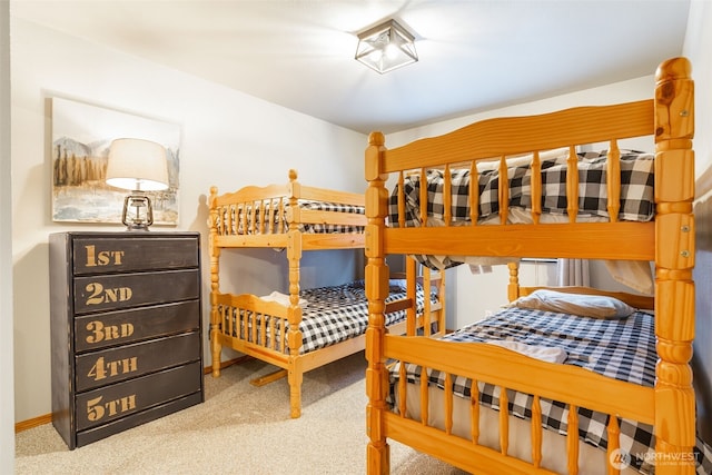 carpeted bedroom featuring baseboards