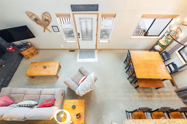 carpeted living room featuring visible vents and baseboards