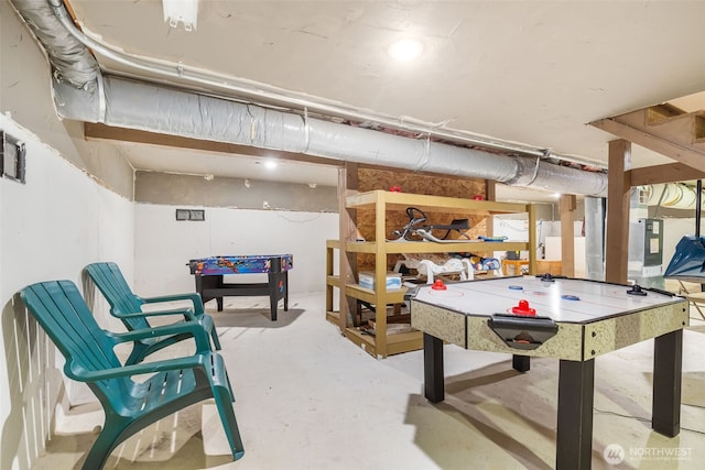 playroom featuring unfinished concrete flooring