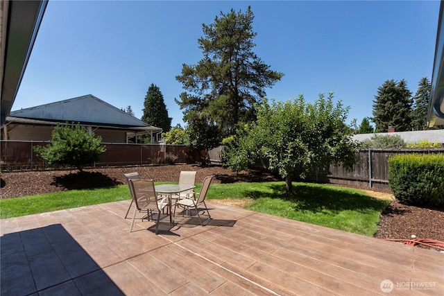 view of patio with outdoor dining area and a fenced backyard