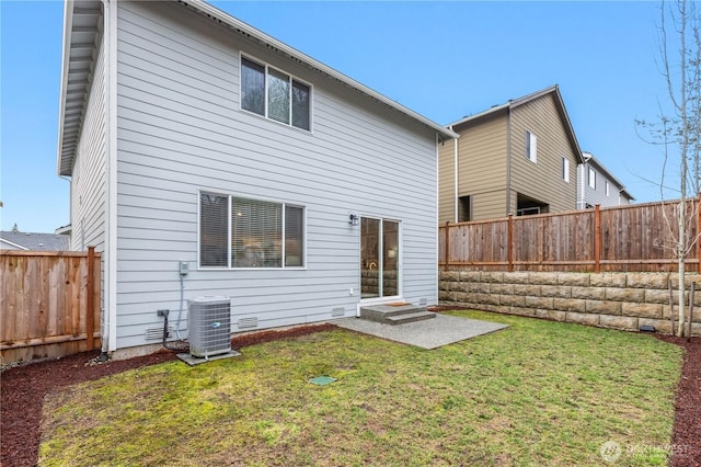 back of property with crawl space, a fenced backyard, a lawn, and cooling unit