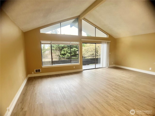 bonus room featuring vaulted ceiling with beams, wood finished floors, visible vents, and baseboards