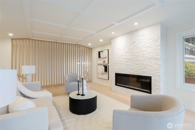 living room with a fireplace and coffered ceiling