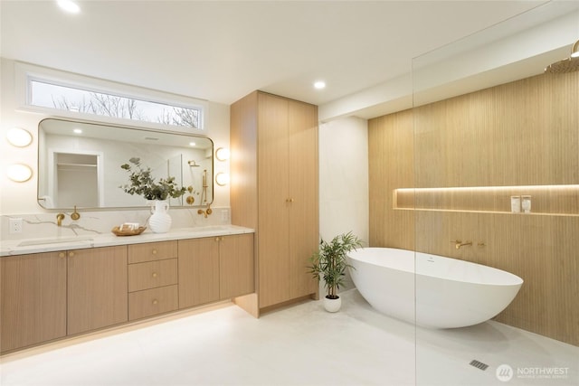 bathroom with a tub and vanity