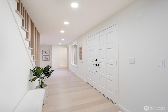 corridor with light hardwood / wood-style floors