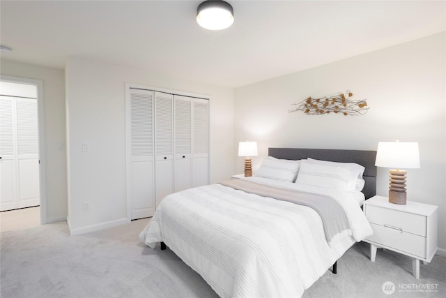 bedroom with a closet and light carpet