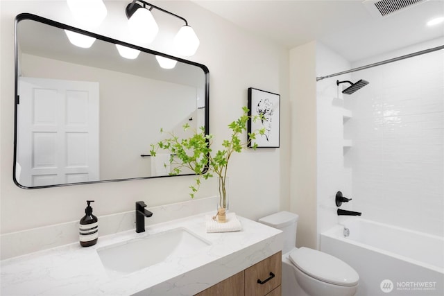 full bathroom featuring tiled shower / bath combo, toilet, and vanity