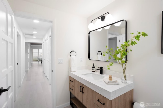 bathroom featuring wood-type flooring and vanity