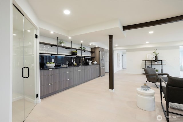 interior space with decorative backsplash and stainless steel refrigerator with ice dispenser