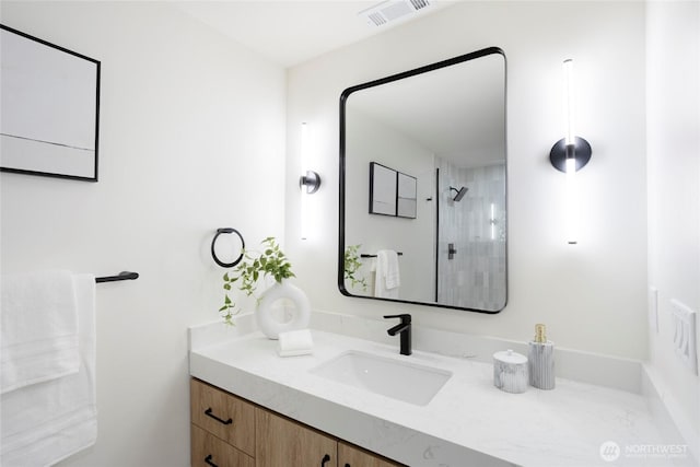 bathroom featuring a shower and vanity