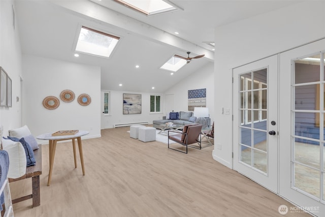 living area with french doors, light wood finished floors, recessed lighting, a baseboard heating unit, and vaulted ceiling with skylight