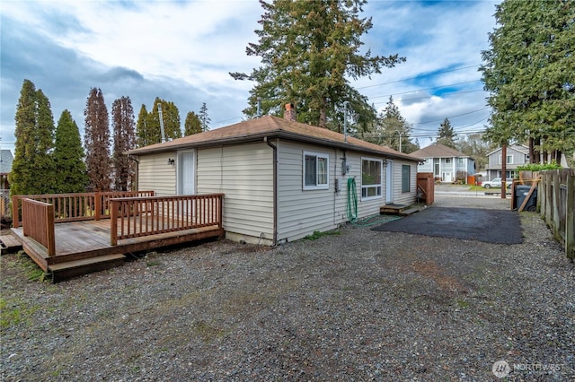 rear view of house featuring a patio and a deck