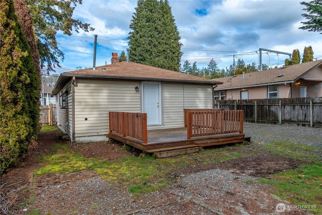 rear view of property with a wooden deck