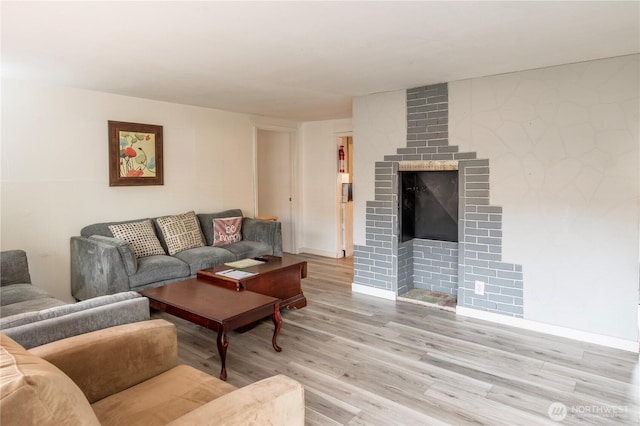 living room featuring a fireplace and light hardwood / wood-style flooring