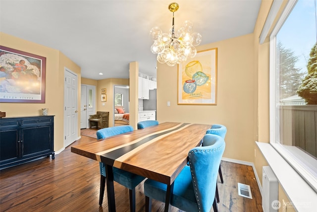 dining room with a chandelier and dark hardwood / wood-style floors