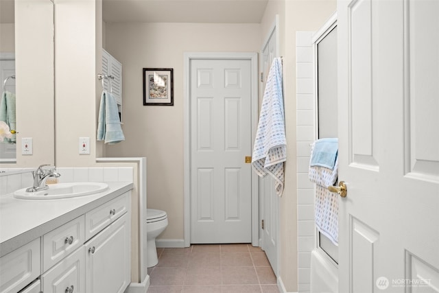 bathroom featuring a tub, vanity, toilet, and tile patterned floors